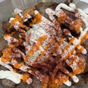 Gyro salad, no onions, plus amazing garlic sauce and spicy sauce.