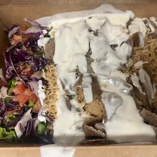 Gyro over rice with salad.
