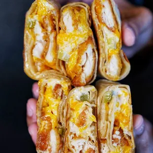 a close up of a person holding a sandwich