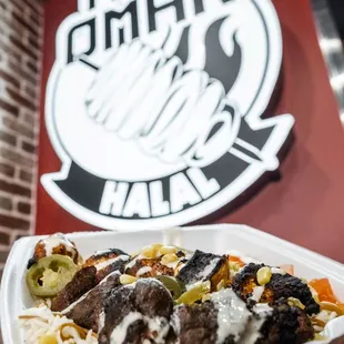 a hand holding a plate of food