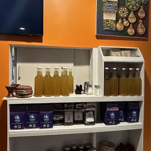 a shelf of honey and jams