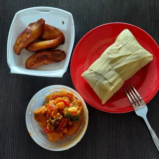 a plate of tamales, a bowl of beans, and a fork