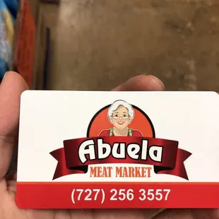 a hand holding a business card