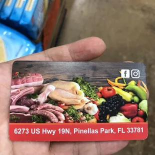 a hand holding a business card