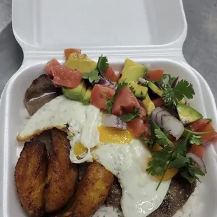 Palmiche: Palomilla steak, fried sweet plantains, two fried eggs, white rice and tomato, avocado, onion salad