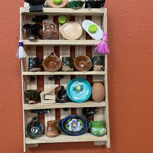 a shelf of dishes
