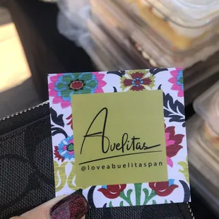 a hand holding a business card