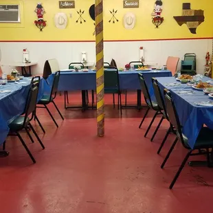 a dining room with blue tablecloths