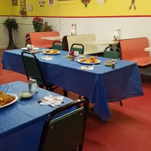 a dining room with blue tablecloths