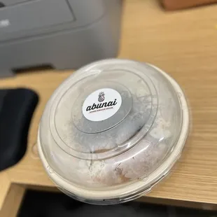 a close up of a plastic container on a desk