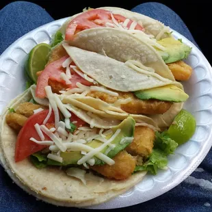 3 fish tacos with tomato an avocado