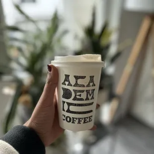 a person holding a cup of coffee