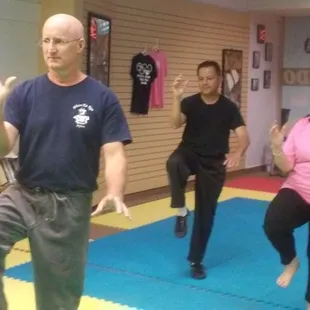 Golden rooster stands on one leg.