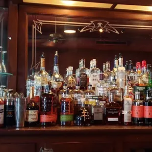 a large selection of liquor bottles on a bar
