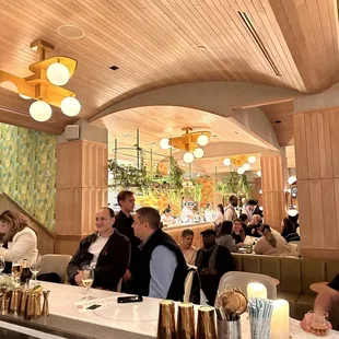 a group of people sitting at a table in a restaurant
