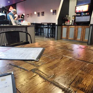 a wooden table with a menu on it