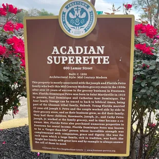 a sign in front of some flowers