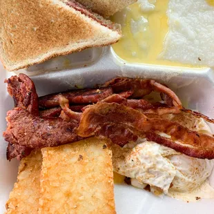 a breakfast of bacon, eggs, toast, and toast