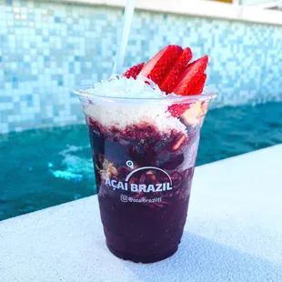 a cup of ice cream and strawberries