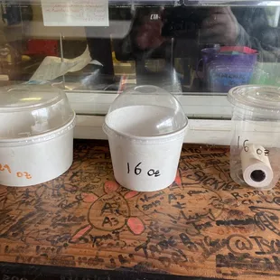 three cups of coffee on a window sill