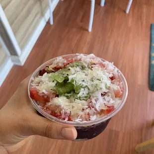 Small bowl with strawberries, kiwis, and coconut