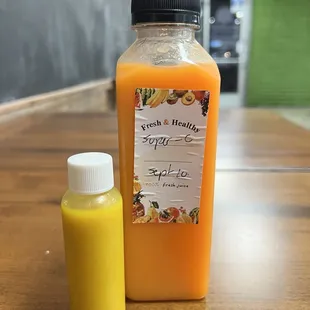 a bottle of orange juice next to a bottle of orange juice