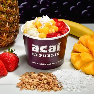 a pineapple, strawberries, and granola