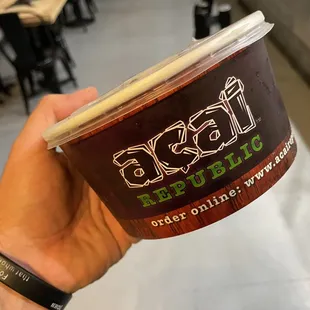 a hand holding a cup of coffee