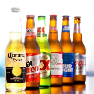a row of corona extra beer bottles