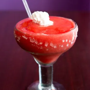 a red drink with whipped cream