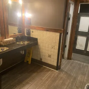 Clean restroom, with exception of some water on the counter