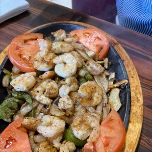 a plate of shrimp and tomatoes