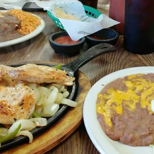 Chicken fajitas. Beans are good. Everything else I could make at home. Enchilada special in the back left corner.