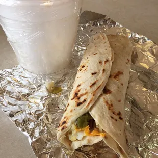 #3 breakfast burrito with bacon. Egg. Potatoes and cheese with green chile. And posole.