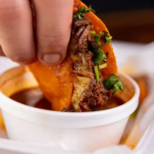 a hand holding a piece of food