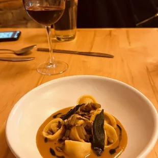 a plate of pasta and a glass of wine