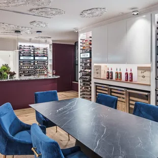 a wine cellar with blue chairs