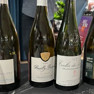 four bottles of wine on a table