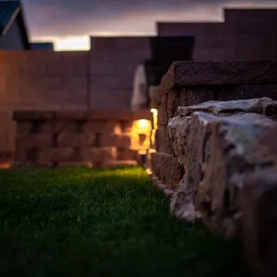 a stone wall with lights