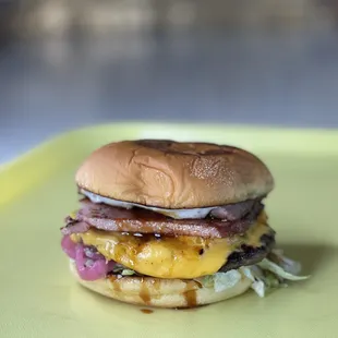 a hamburger on a yellow plate