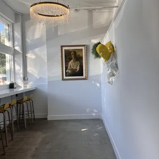 a room with a chandelier and a painting on the wall