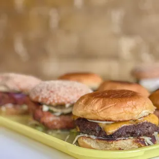 a tray of hamburgers and donuts