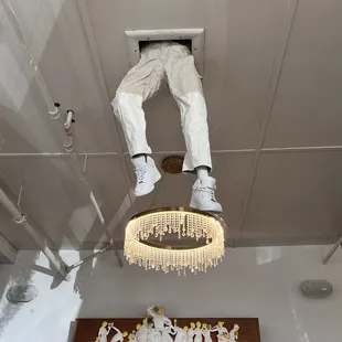 a man suspended from the ceiling