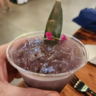 a hand holding a cup of ice cream