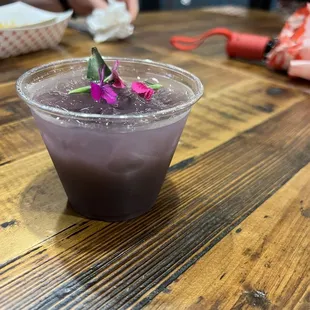 a purple drink in a plastic cup