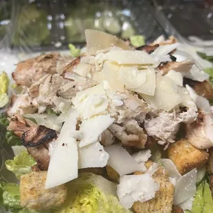 a salad with chicken, cheese, and lettuce