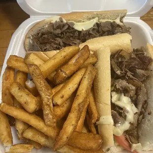 a plate of french fries and a steak sandwich