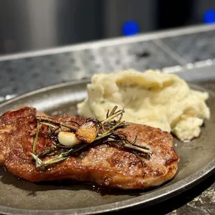 a steak and mashed potatoes on a plate