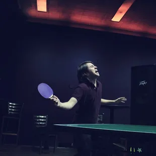 happy ping pong table coupled with aforementioned odd lighting.