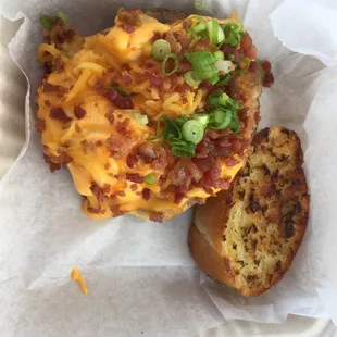 a cheeseburger with bacon and green onions